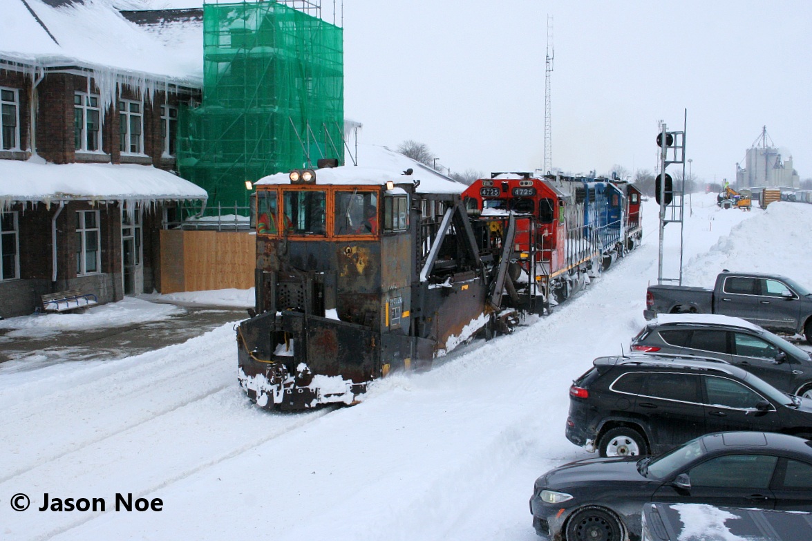 On February 18, CN L540 was sent from Kitchener westbound to Stratford to plow the Guelph Subdivision towards London ahead of that night’s 87. Upon arrival in Stratford, CN L540 lifted Jordan Spreader # 50948 and track department crews prepared it for it’s run west. The power for L540 was 4725, 4910 and 7512. Later, in the afternoon, CN L568 would arrive in Stratford from Kitchener light power and the crews would swap power. 

Here CN L568 is pictured finally departing Stratford passing the station as they begin spreading westward. Reportedly, they made it to a point west of St. Marys before returning east to Stratford later that evening, with that night’s VIA Rail 87 also being cancelled as well.