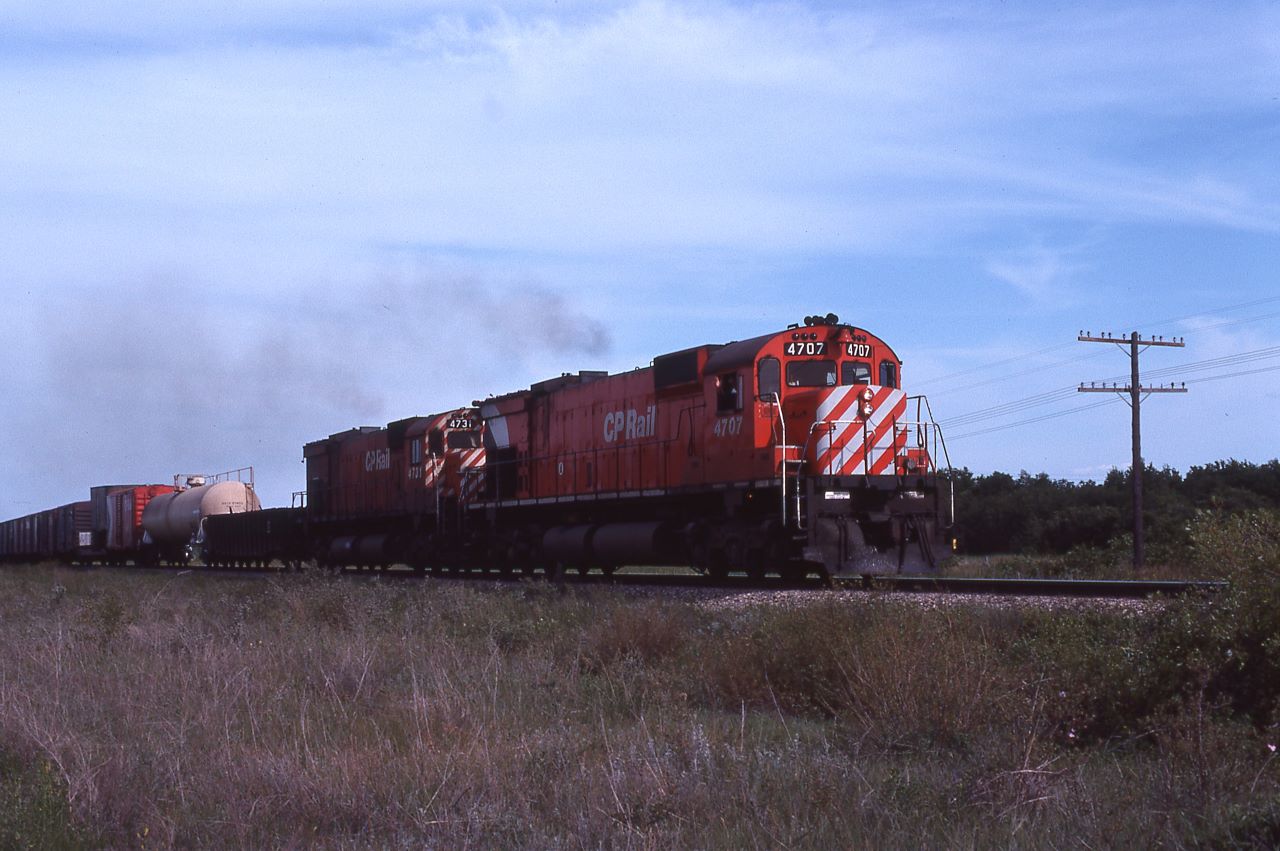 A pair of CP M636s, 4707 and 4731, lead an eastbound freight somewhere in Manitoba.  The location I wrote on the slide has no rail service and the nearest line is about 50 miles away and it is CN (that explains why no map).