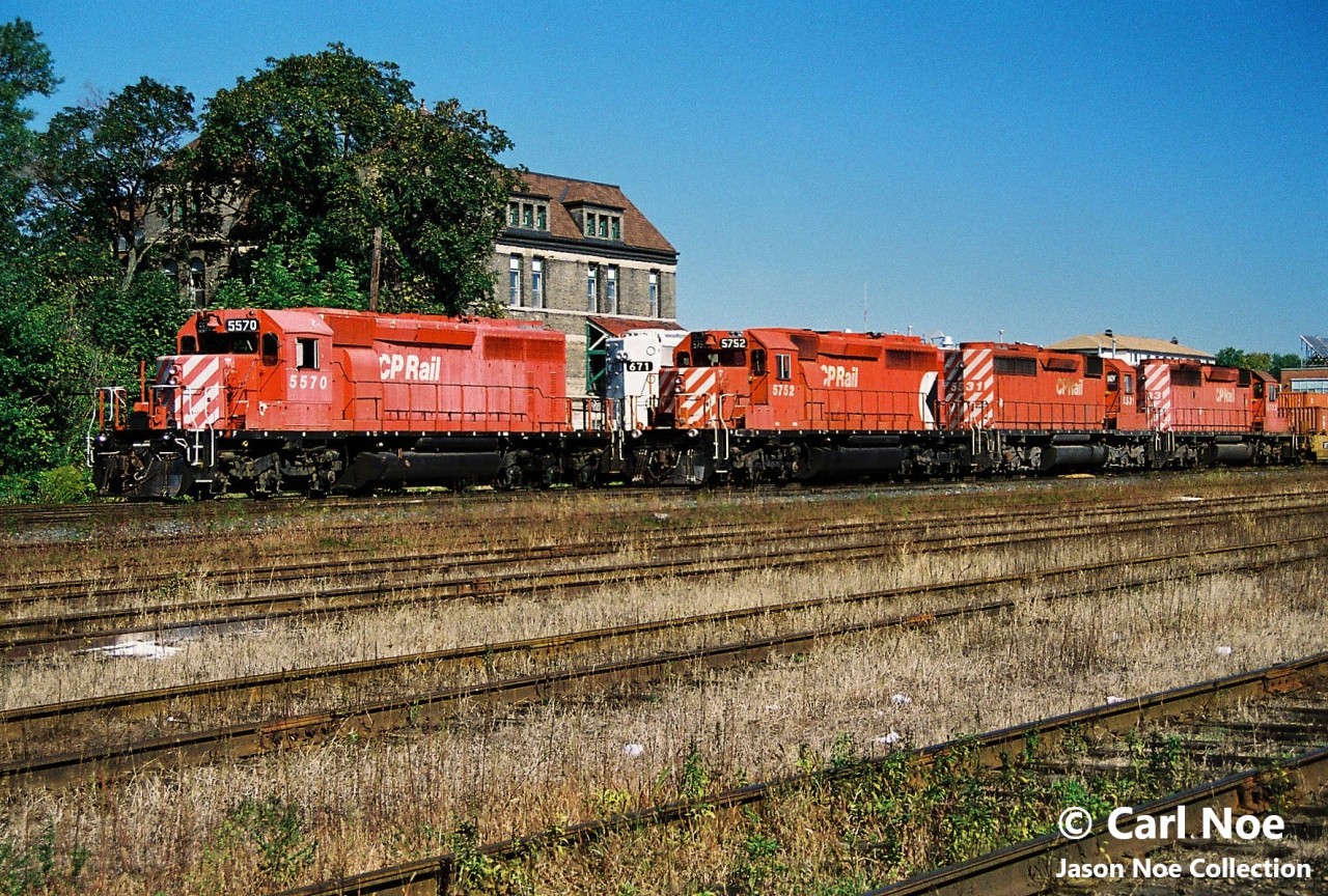 A pair of CP westbound trains await fresh crews to Windsor, Ontario as they idle at the west end of Quebec Street yard in London, Ontario. The consists included SD40-2’s 5570, 671 and 5635, while the other had SD40-2 5752, SD40 5531 and SD40-2 5733. CP 671 was former Kansas City Southern SD40-2 671 and would later be remanufactured to CP 5416.