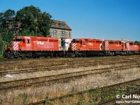 A pair of CP westbound trains await fresh crews to Windsor, Ontario as they idle at the west end of Quebec Street yard in London, Ontario. The consists included SD40-2’s 5570, 671 and 5635, while the other had SD40-2 5752, SD40 5531 and SD40-2 5733. CP 671 was former Kansas City Southern SD40-2 671 and would later be remanufactured to CP 5416.