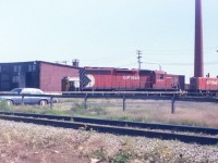 Things have changed since this picture. Big red smoke stack is gone, the little SW's are gone, more of the round house has been removed. Just the part with doors open remains. No more rail liners. The 5531 is retired and sold (2000??) to another road. By how much of the main yard has been removed, it cannot be much longer until CP vacates the property. The Whyte avenue area has been waiting a long time for this to happen. Photo taken with a little 110 pocket camera.