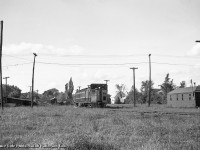 CNR oil electric 15832 swings around the curved Midland Sub station track at the rear of the <a href=https://www.railpictures.ca/?attachment_id=22413>Orillia station</a> with daily except Sunday train 604 from Midland to Lindsay.  The wye to the Newmarket Sub <a href=https://www.railpictures.ca/?attachment_id=48634>("Midland Junction")</a> can be seen off to the left, with the Midland Sub mainline off to the right near the switch stand.  In the distance, tank cars can be seen near the Imperial Oil facility.

<br><br>604 was the return of the westbound 603 earlier that day, operating Lindsay - Blackwater Jct - Lorneville Jct - Orillia - Midland.  The return trip would skip the Coboconk and Uxbridge Sub detours to Blackwater, running straight into Lindsay on the Midland Sub.

<br><br><i>Bruce Cole Photo, Jacob Patterson Collection Negative.</i>