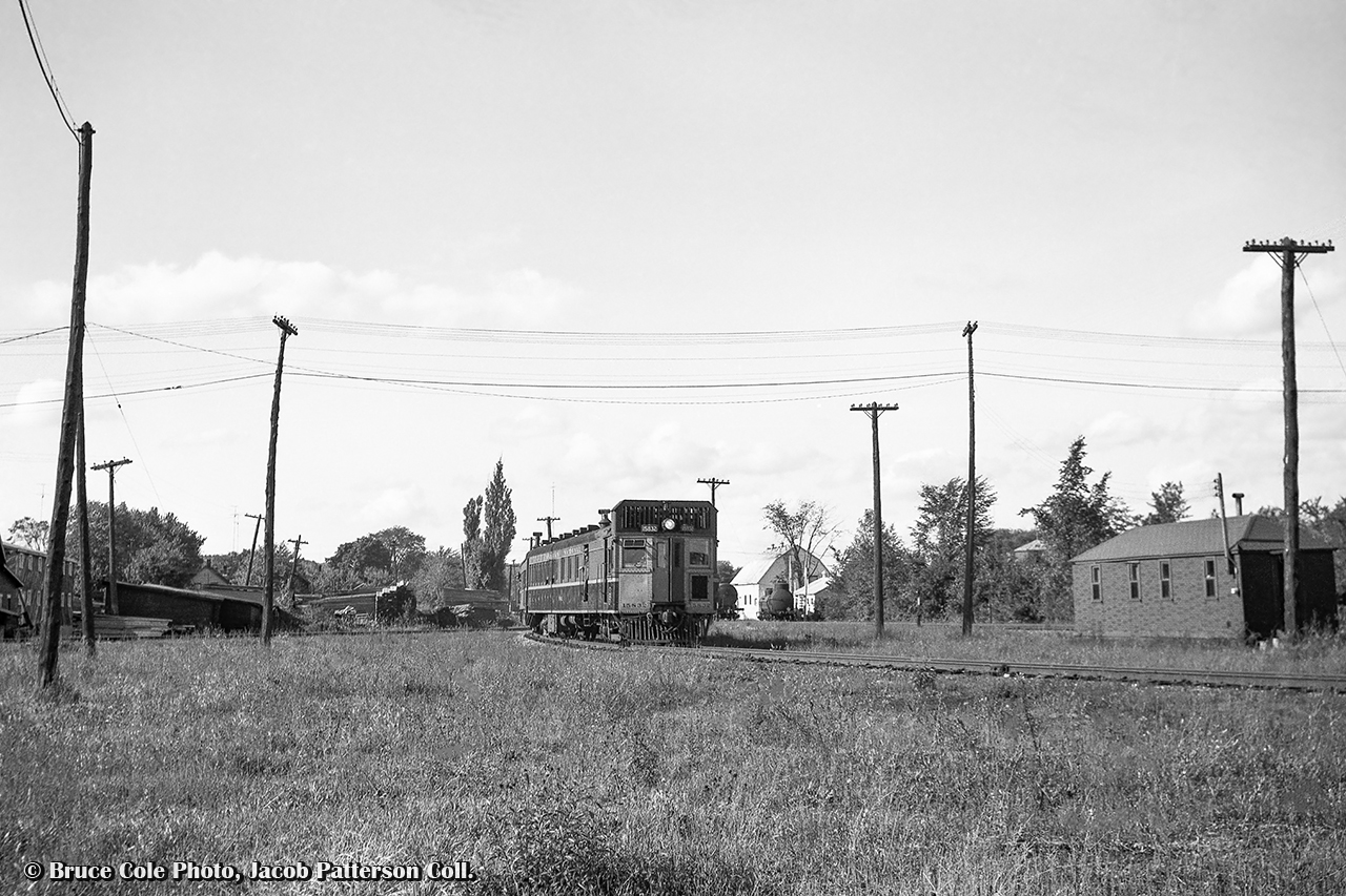 CNR oil electric 15832 swings around the curved Midland Sub station track at the rear of the Orillia station with daily except Sunday train 604 from Midland to Lindsay.  The wye to the Newmarket Sub ("Midland Junction") can be seen off to the left, with the Midland Sub mainline off to the right near the switch stand.  In the distance, tank cars can be seen near the Imperial Oil facility.

604 was the return of the westbound 603 earlier that day, operating Lindsay - Blackwater Jct - Lorneville Jct - Orillia - Midland.  The return trip would skip the Coboconk and Uxbridge Sub detours to Blackwater, running straight into Lindsay on the Midland Sub.

Bruce Cole Photo, Jacob Patterson Collection Negative.