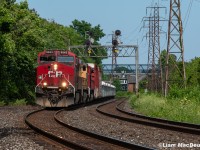 <a href ="https://www.railpictures.ca/?attachment_id=56067">An incredible image taken in 1979 by John Freyseng</a> inspired me to reach into my own archive and pull up this image from only a couple years ago, taken in the exact same spot. Above, CP 421 has a trio of engines up front as it heads west through Rosedale/Summerhill on a nice July afternoon. 

Aside from the signals being changed from an interlocking to a pair of intermediates in the early 80s as well as the service track on the south side being removed, the location hasn't changed all that much in the 40+ years that separates the two images. Unfortunately, fast forwarding to the present day will open up a big change, as in April 2024 the signal bridge (along with every other searchlight on the North Toronto) was torn down. I'm glad to have documented it while I had time, and very grateful for those who were doing it in the decades before me. 