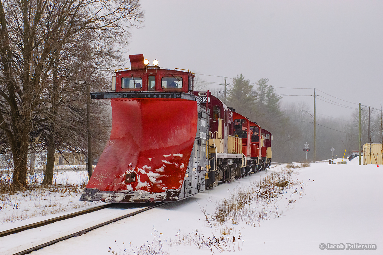 A set of four units tows OSR's plow into Ingersoll en route back to the Salford Shop.  This scene is actually the CAMI Job (1210, 1244, 1245) towing the plow extra (182), which had run into electrical issues a few times during the run to St. Thomas (city limits).  Dying about a mile west of CAMI, the set of pups came to tow the plow back to the shop.

CAMI Job?  While CAMI has not required a dedicated job for a few years, one was run to move a large number of cars between the CAMI yard, used for any traffic at the moment, and CN Beachville.  The Woodstock also was assigned three units (8235, 1620, 1594), and two for the St. Thomas (1591, 102), which met the plow at Belmont.