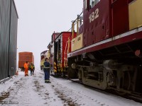 Back at the shop after being towed into town, shop staff have tied 1249 onto the nose of the plow to begin breaking up the consist, while Conductor Sheldon Golden (CAMI Job) confers with Plow Foreman Jack Hyde at left about the days events.  Once inside, crews would begin working on 182 to diagnose the issue at hand.