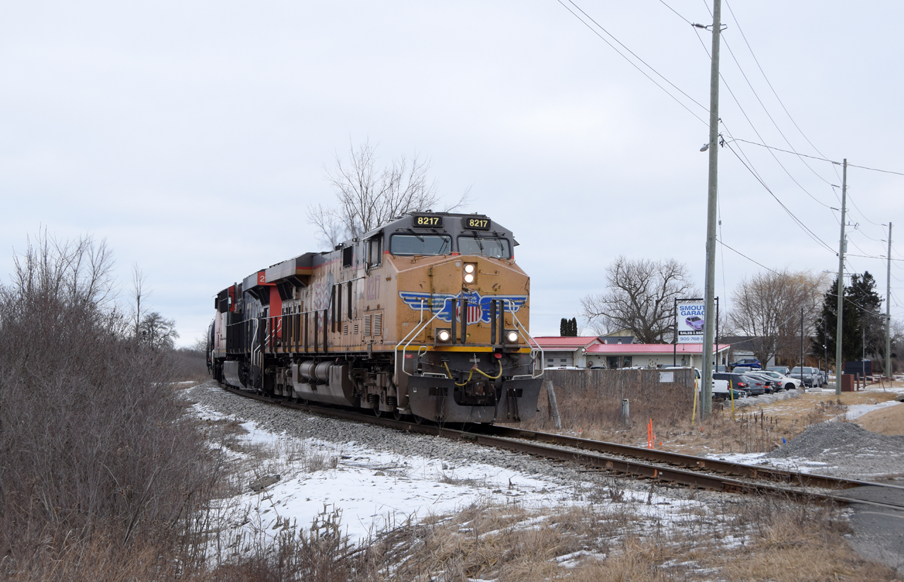 Nearing the end of their journey from Sarnia to Garnet, UP 8217 and CN 2985 lug their 30 car train around the bend as their about to cross highway 6. I'd like to submit this to the "Time Machine" to pair with Bruce Acheson's 1990's posting from this location http://www.railpictures.ca/?attachment_id=47962