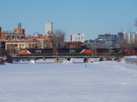 An SD75I leads CN 527 as it crosses the Lachine Canal after holding for CN 324 and CN X400. It has work to do at Pointe St-Charles Yard before it can continue towards Taschereau Yard.