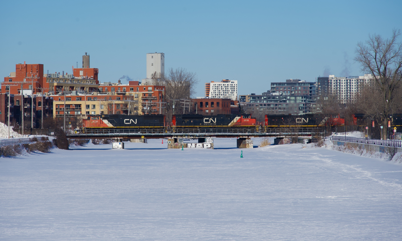 An SD75I leads CN 527 as it crosses the Lachine Canal after holding for CN 324 and CN X400. It has work to do at Pointe St-Charles Yard before it can continue towards Taschereau Yard.