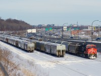 CN 875 has just arrived at Turcot Ouest, where it will get recrewed and refueled before continuing west with grain empties. More grain cars are parked on Track 29 and the Freight Track. 