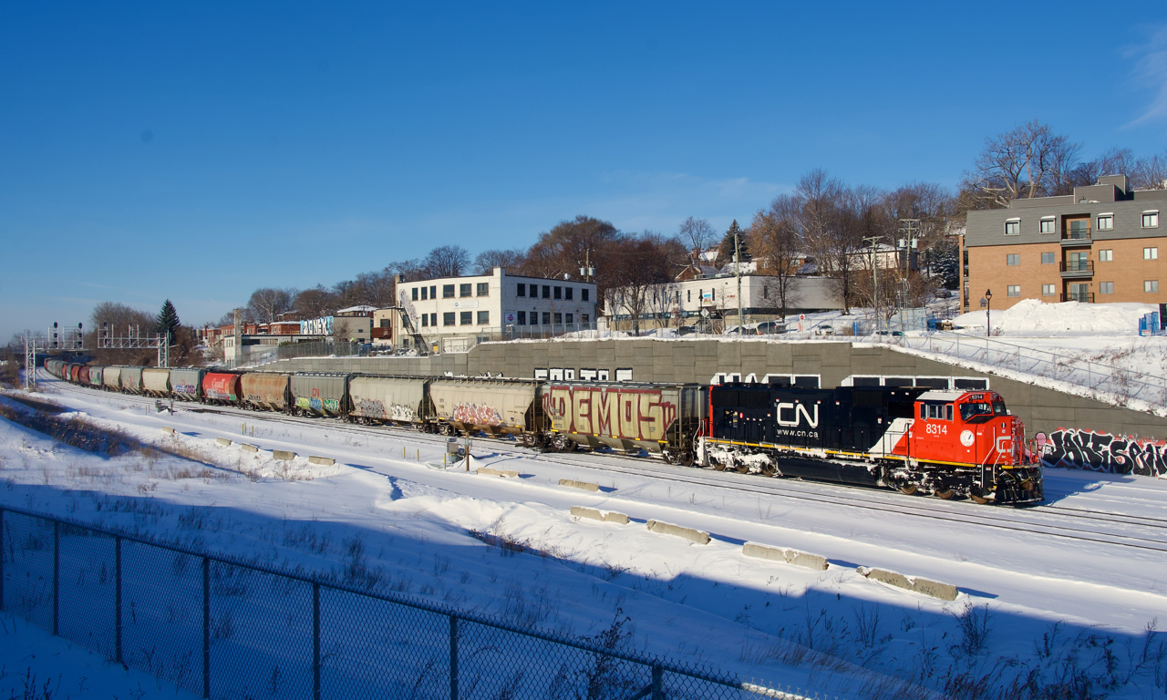 Rebuilt CN 8314 leads grain train CN 874. It is about to tie down and refuel before getting a new crew to take it further east.