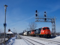 Rebuilt from an SD75I, CN 8311 leads CN 368 as it crosses over at Dorval. Faded CN 2297 trails.