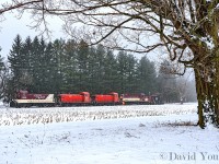 From the moment the plow commenced its day on the St Thomas there were issues. The old MLW would end up tripping a breaker and died numerous times during it's trip down towards St Thomas and back before finally calling it quits just outside Ingersoll. A call was made to the crew of the days CAMI extra who were utilizing a trio of SW1200's. They finished up delivering a handful of racks to CN and ran down to tow the disabled plow back to Salford. Here, near mile 12 some crew members are in the midst of coupling up the hoses before heading for the shop.