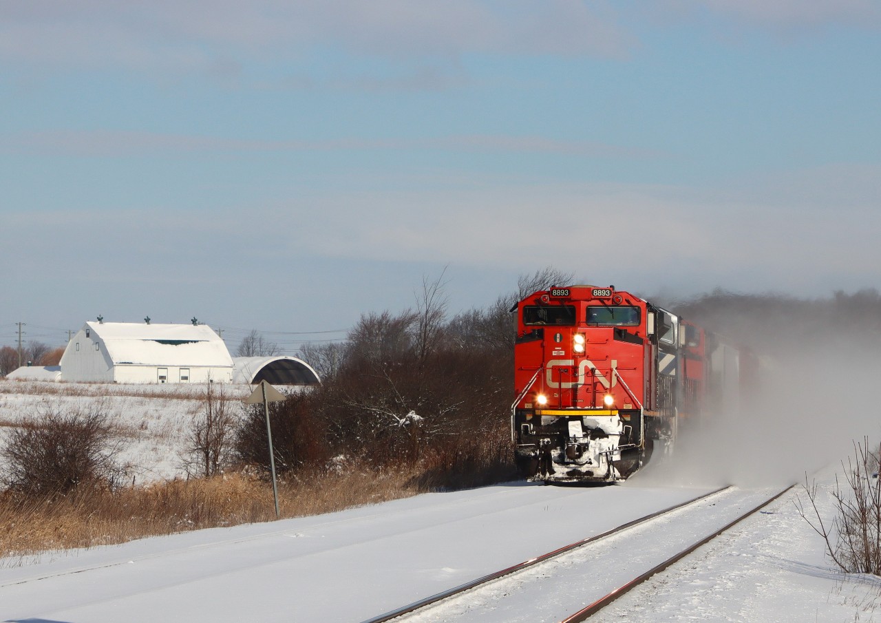 CN 8893 BCOL 4652 CN 8955 are kicking up the snow breaking trail westward on the North Track with 690 axles.