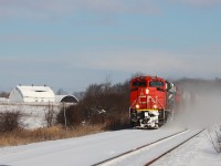 CN 8893 BCOL 4652 CN 8955 are kicking up the snow breaking trail westward on the North Track with 690 axles.

