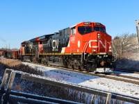 A westbound manifest train with a shiny rebuilt unit (ex-BNSF) in the lead passing Mile 44 Halton Sub..

