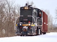 TR 108 is on its way back to Welded Tube after retrieving 1 empty pipe car from CN Southern Yard. Off to the left in the trees is an old stone mile-marker indicating 15 Miles to Fort Erie; apart of the former CASO that used to run along this right of way.