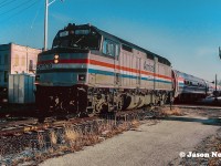 The westbound “International” to Chicago, Illinois from Toronto, Ontario is making its station stop at Weber Street in Kitchener, Ontario on the CN Guelph Subdivision. Train #85 is powered by Amtrak F40PH 287, which will soon continue on to Stratford. At this time, 85 was scheduled in the morning at Kitchener at 09:34, not long after #84, which was due at 09:06, requiring both trains to have a morning meet not far out of the city. 