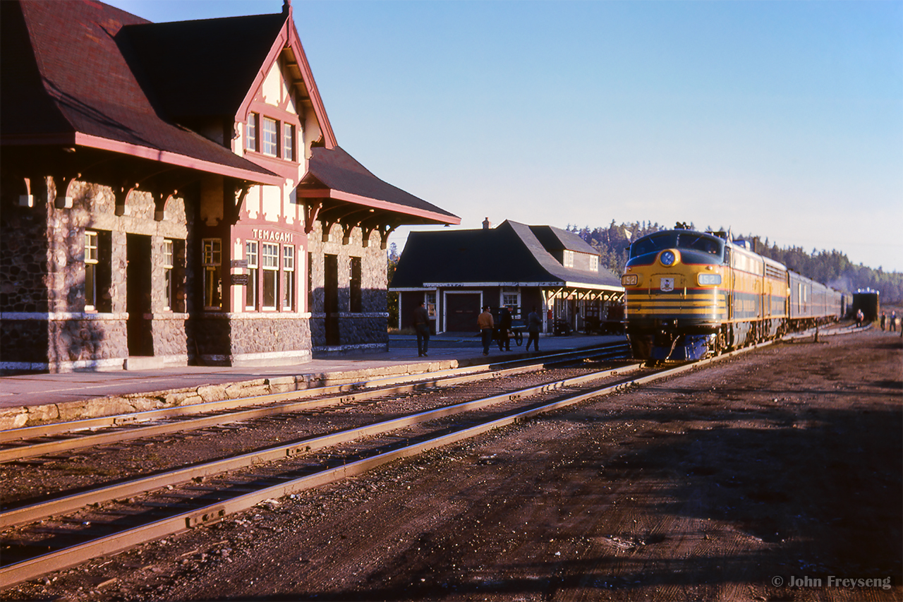 Ontario Northland Railway FP7s 1521, 1511 sit in the crisp rays of the morning sun at Temagami on the head end of the Upper Canada Railway Society excursion from Toronto via Ottawa.  The excursion had arrived in North Bay from the nation's capital late in the evening of Sept. 14 to be handled overnight to Temagami, allowing a well lit run south to North Bay.


The weekend of September 13 - 15, 1963 marked a massive undertaking by the Upper Canada Railway Society, a 692.2 mile excursion from Toronto - Ottawa - North Bay - Temagami - Toronto, with seventeen coaches behind CNR 6167. With the train having run overnight from Toronto - Ottawa on the 13th, the train turned west and departed the nation's capital early on the 14th. 6167 would be removed at North Bay, with ONR FP7s handling the train to Temagami overnight. The consist returned to North Bay on the morning of the 15th, with 6167 taking over once again for the return to Toronto.

Further information will be detailed in upcoming posts, but can also be found in the December 1963 UCRS news letter.


Scan and editing by Jacob Patterson.