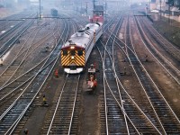 CPR 360, the Budd cars from Windsor, move through the TTR interlocking, ducking beneath the Bathurst Street bridge as they approach Union Station.  Note the switchtenders sitting in chairs near their shanty, waiting to line up the next movement.

<br><br><i>Scan and editing by Jacob Patterson.</i>