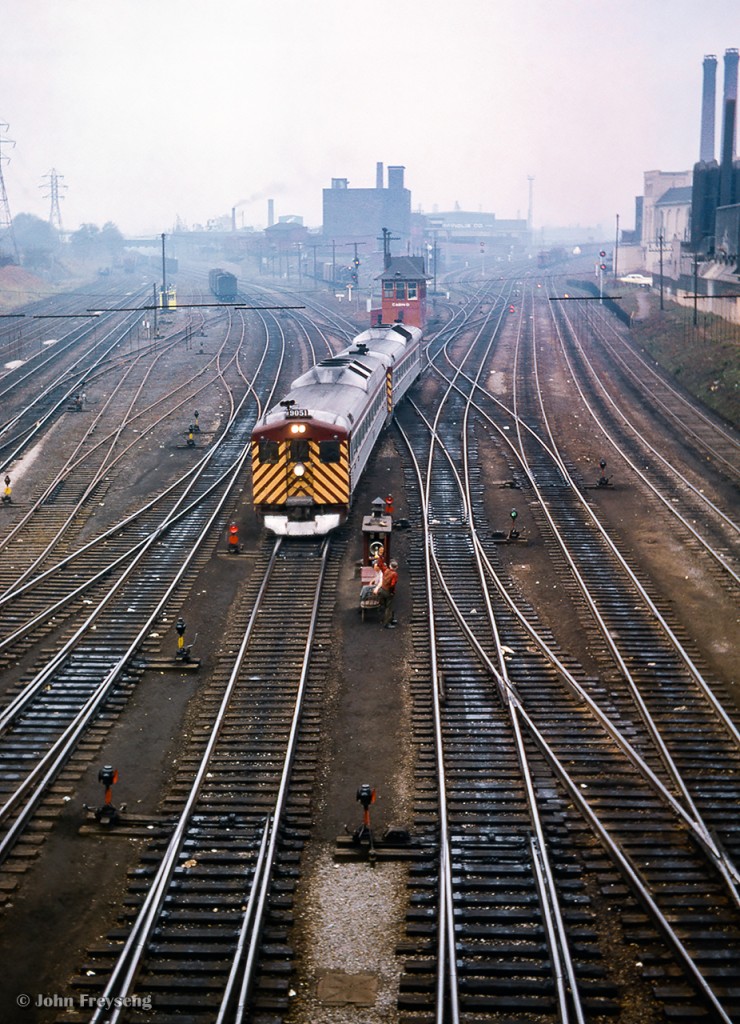 CPR 360, the Budd cars from Windsor, move through the TTR interlocking, ducking beneath the Bathurst Street bridge as they approach Union Station.  Note the switchtenders sitting in chairs near their shanty, waiting to line up the next movement.

Scan and editing by Jacob Patterson.