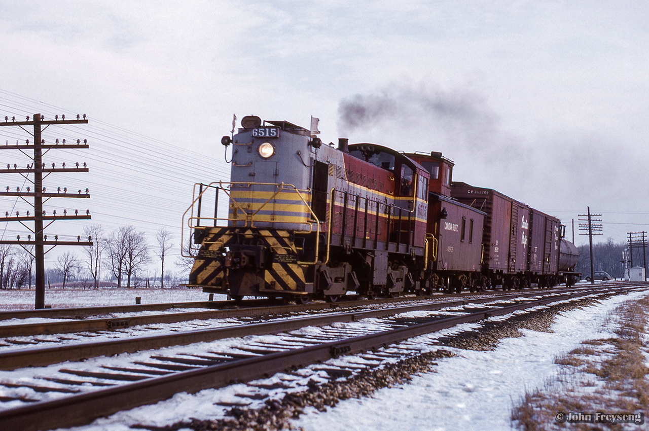 CPR 6515 works west along the Galt sub with a Lambton - Guelph Junction wayfreight, having just crossed Winston Churchill Blvd in Lisgar.

Scan and editing by Jacob Patterson.