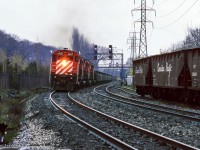 A rainy spring day finds four of CP's 6-axle MLW fleet handling an extra west through Toronto's Summerhill neighbourhood.  Note the siding at right which led to industries south of the mainline between Mount Pleasant Road and Yonge Street, near the old <a href=https://www.railpictures.ca/?attachment_id=15510>CPR North Toronto Station.</i>


<br><br><i>Scan and editing by Jacob Patterson.</i>