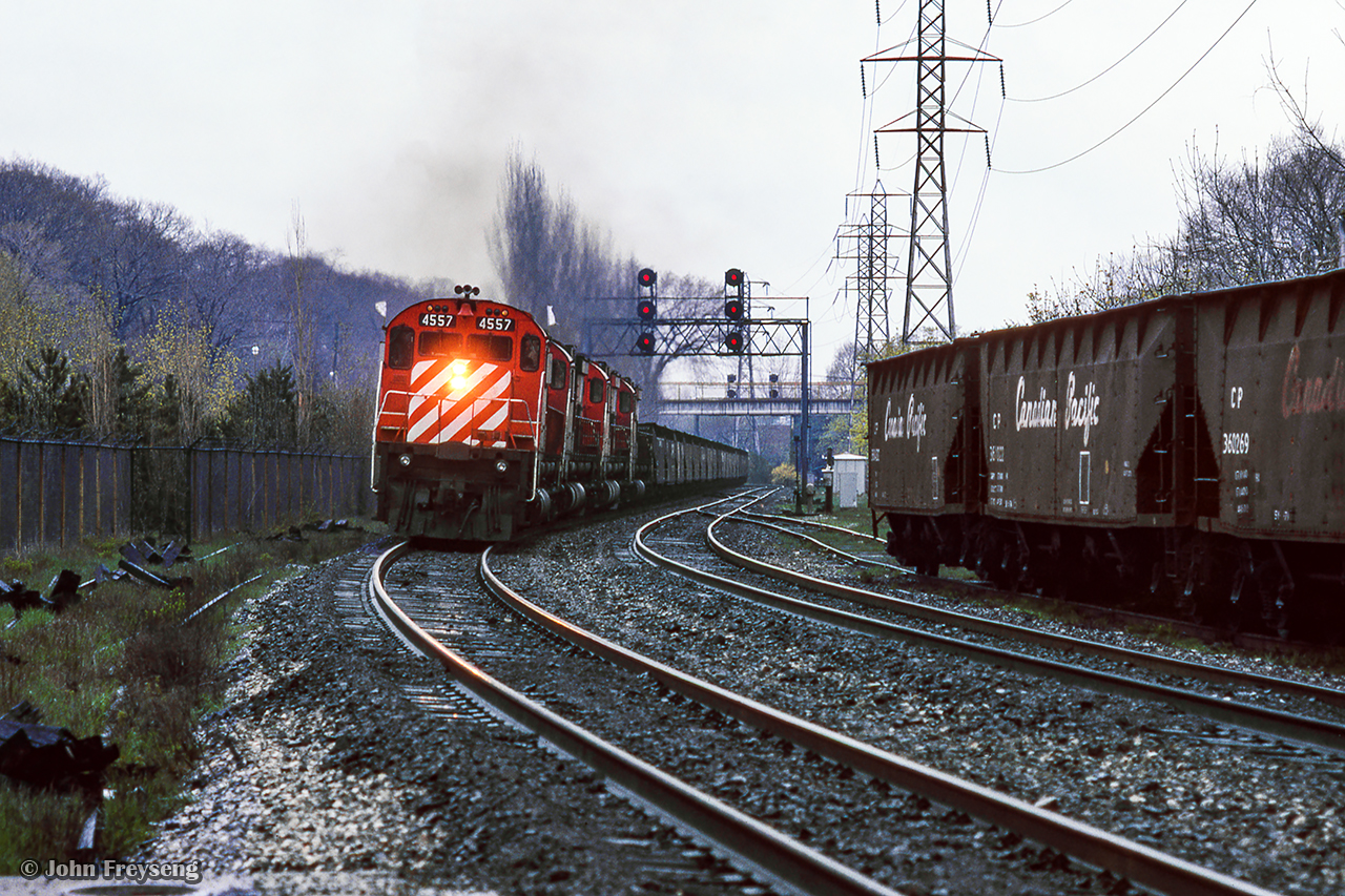 A rainy spring day finds four of CP's 6-axle MLW fleet handling an extra west through Toronto's Summerhill neighbourhood.  Note the siding at right which led to industries south of the mainline between Mount Pleasant Road and Yonge Street, near the old CPR North Toronto Station.


Scan and editing by Jacob Patterson.