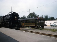 By the late 1950's it was clear that Steam's days were numbered, and Interurbans were almost non-existent.  The combination of the two may have been Roger Bloomquist's inspiration to travel from Indiana to Port Colborne to capture Mikado 3422 and NS&T 83 in this idyllic scene.  The building in behind is the local CTC (Canadian Tire) downtown location that was on site until the mid-80's.  The view is looking west, 3422 is traveling east bound on the Dunnville Sub, likely on the afternoon scheduled Stratford - Fort Erie run.  The NS&T has less than 2 years of Thorold to Port Colborne service left.  TH&B GP-7's were active here at that time... imagine a photo with a Maroon & Cream Diesel and you would have the Trifecta !  Thanks to Steve H for help here.