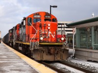 With their train stretching back to Oakville Yard on Track 1, L554 with veteran CN 4116 leading moves slowly through Oakville GO station heading toward Aldershot. Once the tail end clears Oakville Yard the throttle will get pulled back and they will be on their way.

