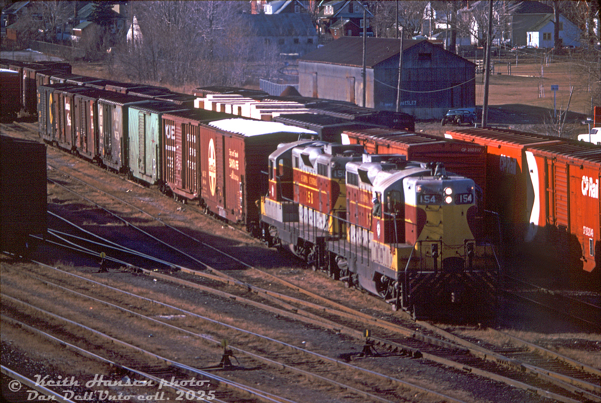 Algoma Central Railway GP7's 154 and 150, leased by CP Rail for a few months in 1978-79, handle CP's Cobourg Turn from Toronto as they switch cuts of cars in the small yard west of Ritson Road South in Oshawa.

It's hard to make out, but CN's former Oshawa Railway line runs north across the top of the image, perpendicular to CP's line (and crossing it at a diamond). The small CP yard here served as the interchange between CP and CN, that helped feed boxcars full of auto parts coming off CP to the GM automotive assembly plants in the north end of the city along the Oshawa Railway switched by CN (there was a CN restriction that didn't permit cars longer than 52'6" unless authorized, and 60' cars permitted for only a few sidings). 50' boxcars from Santa Fe, Southern, DT&I, N&W, CP, CP and C&O/B&O are visible, likely carrying automotive components originating at assembly plants in different parts of North America.

Keith Hansen photo, Dan Dell'Unto collection slide.

A more modern view after CN's Oshawa Railway operations ended: http://www.railpictures.ca/?attachment_id=23535