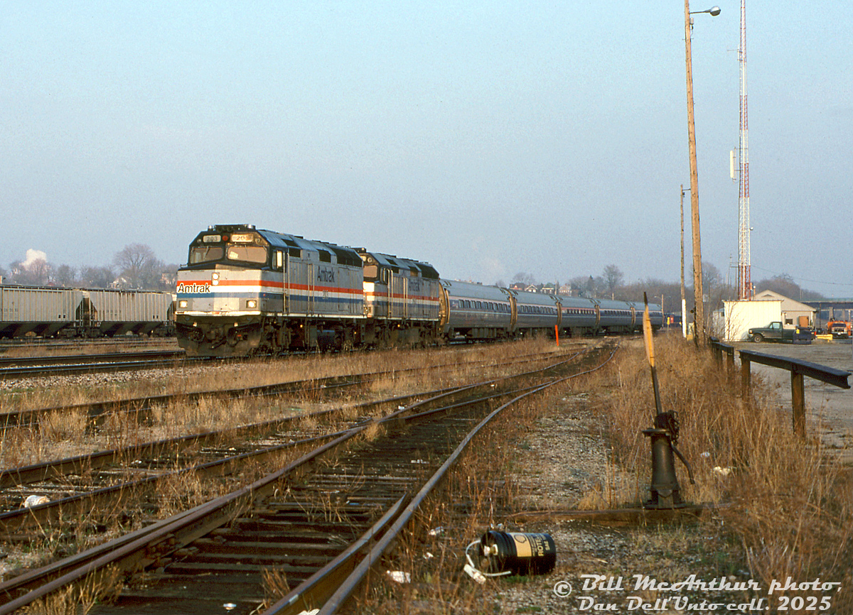 Nearing the end of their careers on Amtrak, F40PH units 203 and 260 pull joint Amtrak-VIA train #98, the Maple Leaf, past the SOR/CN Stuart Street Yard on the Canadian leg of their trip from Niagara Falls to Toronto. The leads for the diesel shop can be seen in the foreground, and the yard office on the right. By this point in time, trains weren't stopping at the former CN Hamilton (James Street) station off in the distance anymore.

Bill McArthur photo, Dan Dell'Unto collection slide.