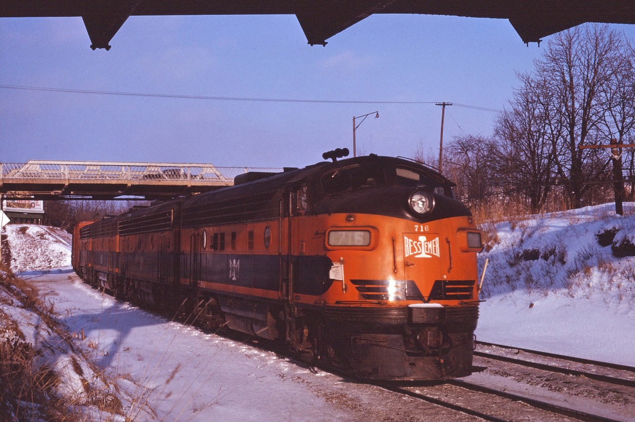 Here's another shot from early 1964 when CN was leasing B&LE F units due to a traffic surge. The train will continue on into Hamilton and down to Niagara behind its ABBA consist of F7s. (For those not familiar with the setting, I'm standing below the old Snake Road bridge and that is the old Plains Road bridge in the background.)