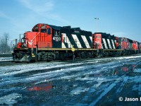 CN train 511 is ready to depart CN’s London East Yard with quite a consist that was not typical of the time for the London-Sarnia turn. The unit’s included CN GP9RM’s 4100, 4115, GP40-2L(W)’s 9608, 9569, 9453 and brand new Burlington Northern SD70MAC 9526. The day prior on February 16, 1995 CN train 272 had collided with the rear of stationary train 308 at Mile 4.2 of the Strathroy Subdivision in London, Ontario at CN Hyde Park. The resulting derailment and clean-up had closed the line until the following day and the three GP40-2L(W)’s were likely being taken to Sarnia to assist with motive power needs following the incident. BN 9526 was just released from the GMDD facility in London and was heading for interchange with BN in Chicago, Illinois. 