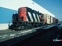 At one time, the CN Galt Industrial Spur in Cambridge was a thriving section of track that saw daily service during the week by a local job based out of Kitchener. Branching-off the Fergus Spur near Highway 401, the spur was the regular destination for CN 580 during the 1990’s. Two customers, McPherson and Inglis were situated at the end of the spur where it crossed Franklin Boulevard and provided the bulk of the traffic for the CN local. However, in November 1994, Inglis had announced that appliance production at the factory would be phased out by the second quarter of 1995. 
<br>
Here in December 1994, CN 580 with GP9RM 4134 patiently waits as Inglis workers completed loading boxcars with new locally manufactured appliances for Canadian markets. At some point in 1995, the facility loaded its last boxcars and closed, leaving one less customer on the spur. Interestingly, both tracks still remain in place today, although disconnected, and the large building is used for office space as well as by children’s clothier Carter's Oshkosh. 
