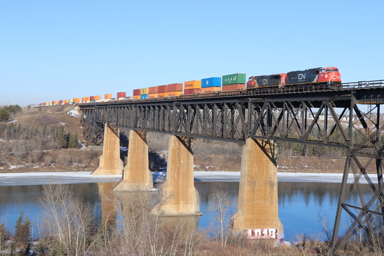 Approaching Bretville Jct, A 44251 crosses the North Saskatchewan river before turning south and heading for Calgary. 67 cars (intermodal up front and merchandise on the tail end) behind SD75ACC 8301(rebuilt from 5684) and IC 2707. The chase is on!