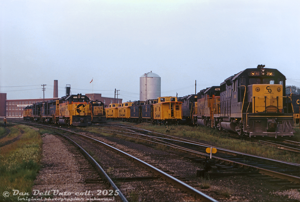 A gaggle of second-generation EMD road power congregates on the yard tracks at Chesapeake & Ohio's St. Thomas shops, including plenty of GP30's, GP35's, and GP40-2's in earlier C&O blue & yellow bookend paint and later Chessie System "circus" colours. Readable units are C&O 4168, 3539, 3560 and 4176, and cabooses 3663, 3664?, 3529, 3507 and 3528 are parked among them. The roundhouse and turntable are out of view to the right. Scenes like this at St. Thomas would vanish in the next decade, as C&O's facilities here would be abandoned in the mid-80's and demolished (the roundhouse bays and turntable pit on the former property are still visible in aerial imagery today).

Original photographer unknown, Dan Dell'Unto collection slide.