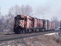 CP GP30 5000 leads a pair of C630s, 4559 and 4562, west over what possibly could be Islington Avenue on March 7th, 1987.  The city may have encroached on this location a little in the 38 years since the photo was taken. I did not like chasing trains this time of year; the days were warmer, longer, and inviting, but nothing was green yet.