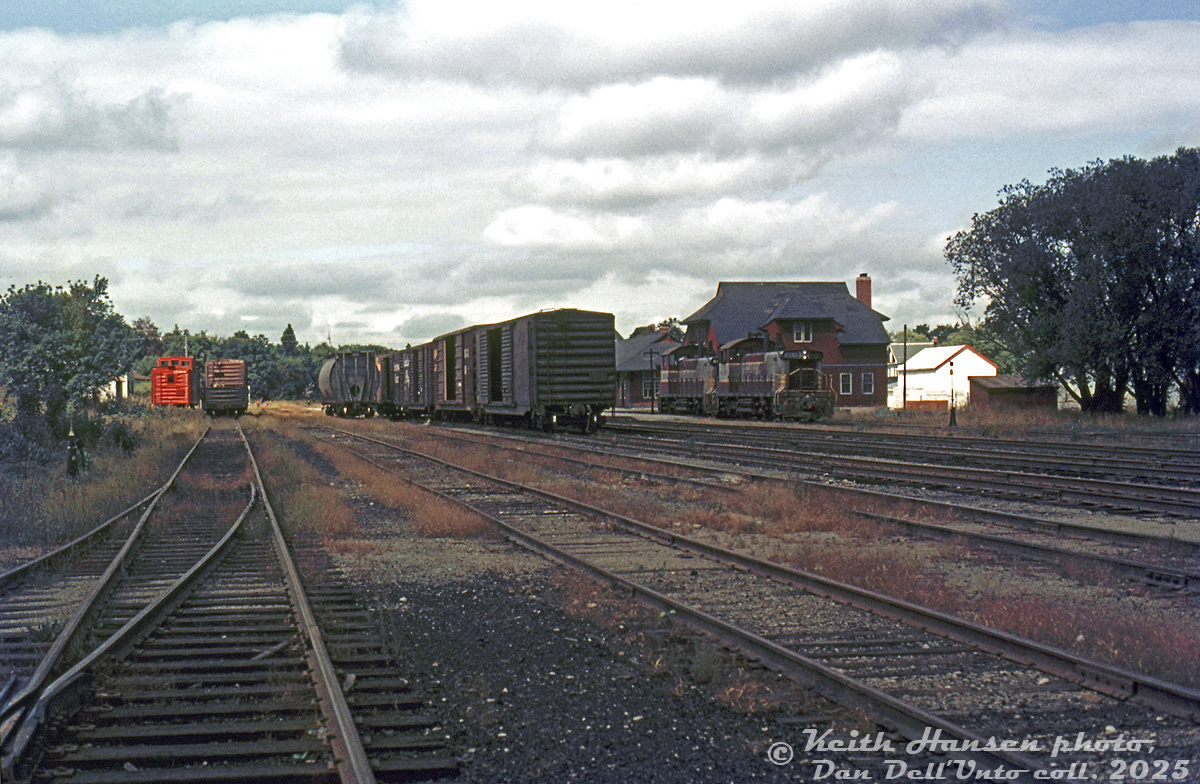 A look from inside Canadian Pacific's Orangeville Yard on a slightly overcast day in September 1973 shows a bit of equipment lingering around. This view is looking north to Town Line, showing a pair of CP SW1200RS "BLU" (Branch Line Units) parked near the old bunkhouse, with part of the station visible further back. A few cars sit in the yard, with the red ends of a flanger car visible on its own. The switch to the Clorox plant siding is visible in the foreground.

At the time there were still numerous branchlines radiating from the Orangeville area to the north and west. Over time as those branchlines were abandoned, Orangeville's importance as a junction point diminished. It had about a two-decade reprieve when the Orangeville Brampton Railway acquired the line from CP in 2000, but finally succumbed to economic and political pressure at the end of 2021.

Keith Hansen photo, Dan Dell'Unto collection slide.