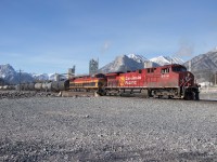 Aided by howling west winds, CPKC200 (Coquitlam-Clover Bar, AB) rolls through Exshaw behind AC4400CWM 8114, KCS AC4400 4620 and mid-train DPU KCS 4617.