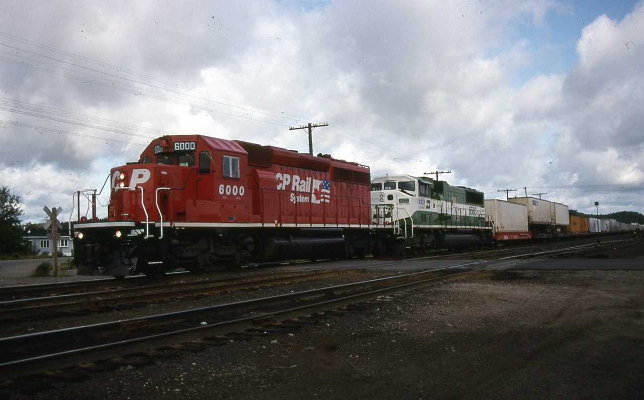 CP southbound with dual flags new paint leading at Cartier station trailing one of 3 BN units that CP borrowed to test out.