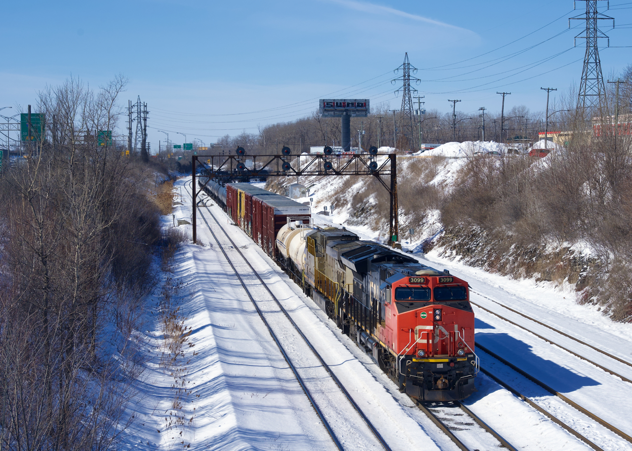 CN 324 is exiting Taschereau Yard with CN 3099 & CN 2772 for power. It is heading to St. Albans to interchange with the New England Central Railroad.