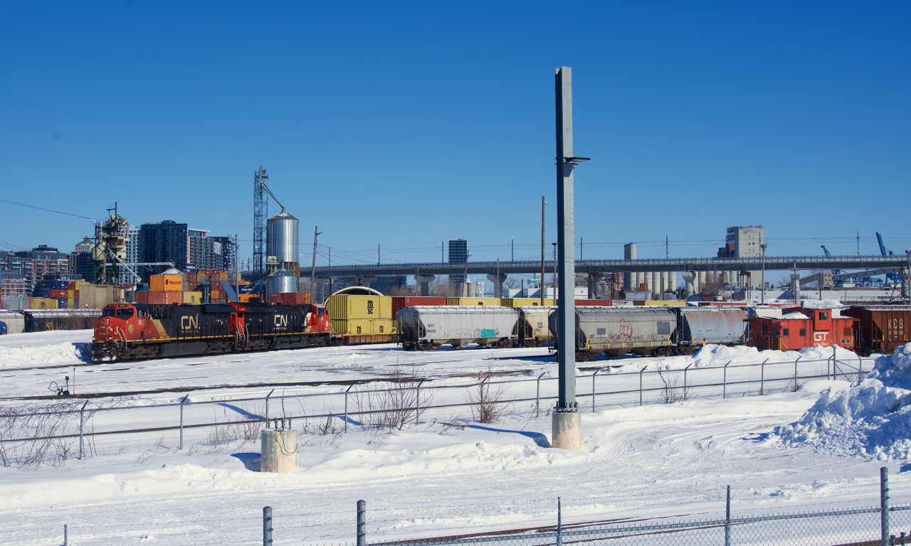 CN 149 is passing Pointe St-Charles yard on a frigid morning with CN 3817 & CN 3286 for power. At far right is the Pointe St-Charles' caboose, it will be shoving westwards once CN 149 clears.