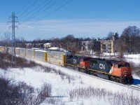 After being held a few miles west of here due to congestion, autorack train CN 276 is blasting through Pointe-Claire with an SD75I/Dash9-44CW lashup. It would have to cool its heels again in Lachine before finally being able to enter Taschereau Yard.