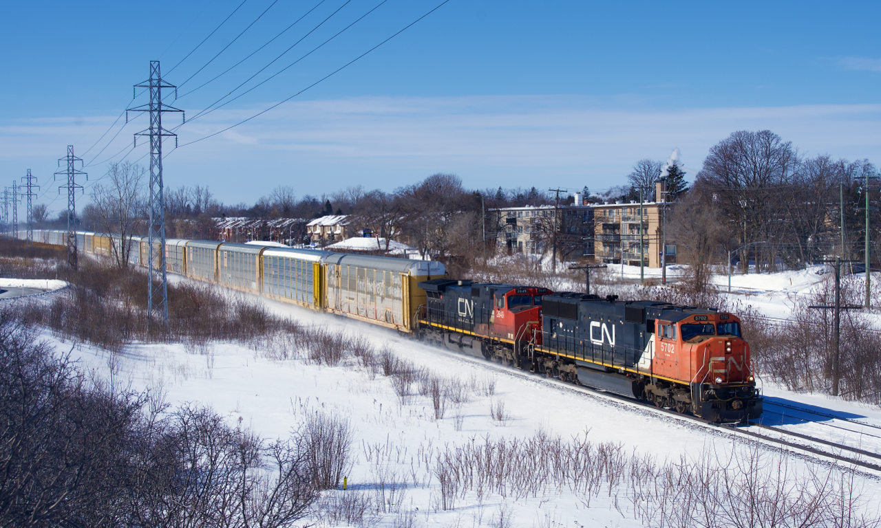 After being held a few miles west of here due to congestion, autorack train CN 276 is blasting through Pointe-Claire with an SD75I/Dash9-44CW lashup. It would have to cool its heels again in Lachine before finally being able to enter Taschereau Yard.