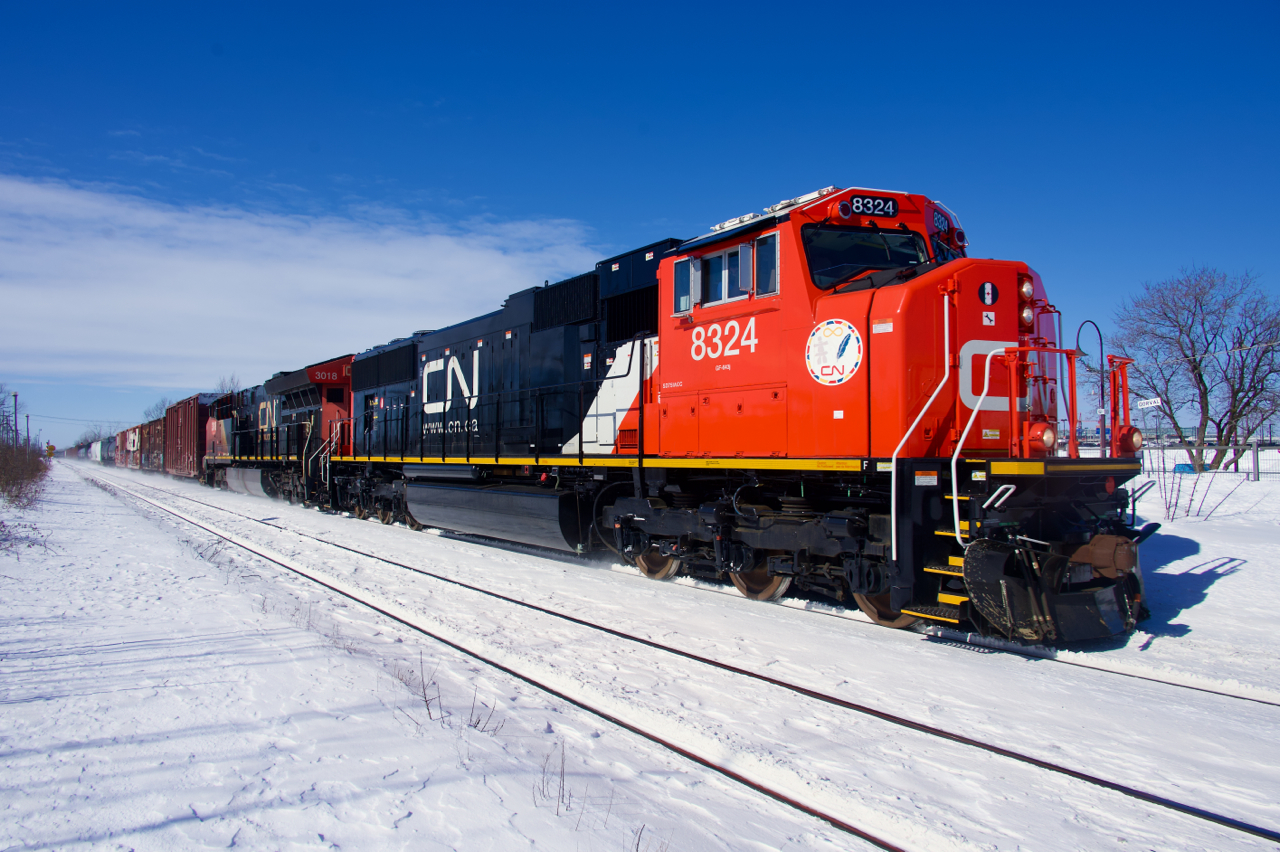 Freshly rebuilt CN 8324 leads CN 368 through Dorval, with CN 3018 trailing.