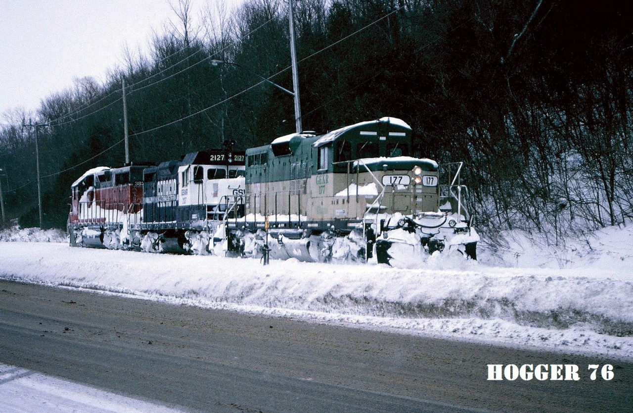 Goderich-Exeter Railway train 581 is pictured reversing light power at the Goderich, Ontario harbor where it will lift several hoppers from the large Sifto salt mine. Powering the consist are GEXR GP38 3821, GSWR GP7u 2127 and GEXR GP9 177.