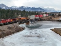 CPKC 112-23 leaves the Rocky Mountains behind as they enter the foothills of Alberta.  After some power moves in Calgary, the train will be traversing the Canadian Prairies. CPKC 112-23: CP 9830, KCSM 4756, CN 3274, CN 3122 - DP 2x1x1