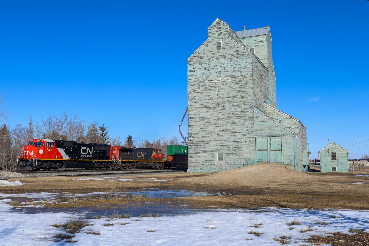 A 44251 04 rolls past the elevator at Camrose with SD75IACC 8301 leading.