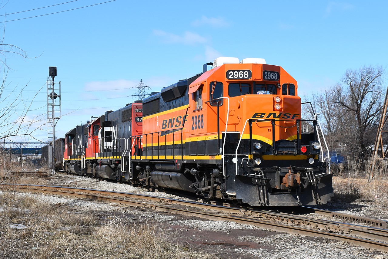 BNSF 2968 leads the CN Hamilton 06:00 job on their second trip down the N&NW Spur this morning with two gondolas for Triple M Metal by Parkdale Yard. The train is photographed at the CP diamond just west of Gage Avenue North.